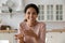 Young Hispanic woman sit indoor participate in video call communication