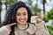 Young hispanic woman smiling confident holding smile reminder at park