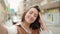 Young hispanic woman smiling confident making selfie by the camera at street