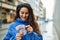 Young hispanic woman smiling happy counting sweden krone banknotes at the city