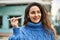 Young hispanic woman smiling happy plane toy at the city