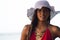 Young Hispanic Woman in Sun Hat at Beach