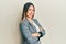 Young hispanic woman wearing business clothes with arms crossed gesture smiling with a happy and cool smile on face