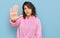 Young hispanic woman wearing casual sweatshirt doing stop sing with palm of the hand