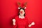 Young hispanic woman wearing deer christmas hat and red nose very happy and excited doing winner gesture with arms raised, smiling