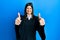 Young hispanic woman wearing judge uniform approving doing positive gesture with hand, thumbs up smiling and happy for success