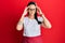 Young hispanic woman wearing professional waitress apron with hand on head for pain in head because stress