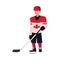 Young hockey player in Canadian uniform standing and holding stick
