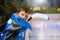 Young hockey player standing behind rink boards