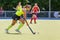 Young hockey player woman with ball in attack