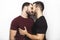 Young homosexuals gay couple love each other on a white background.