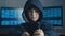 Young hooded boy using a smartphone device. Portrait of genius boy wonder hacks system at cyberspace.