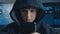 Young hooded hacker kid using a smartphone device to hijack. Genius boy wonder hacks system at cyberspace.