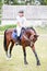 Young horseback girl on the bowing horse