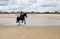 Young horsewoman galloping on the beach in northern France