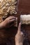 Young house wife preparing the homemade pasta at kitchen. Woman cutting long dough stripe for cooking pasta