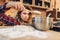 Young housewife in an apron puts flour in a bowl