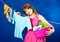 Young housewife hanging clothes on clothesline