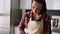 Young housewife mixing cake ingredients in bowl