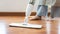 Young housewife mopping and cleaning the wooden floor