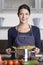 Young housewife preparing a healthy Italian pasta