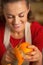 Young housewife removing orange peel