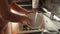 Young housewife washing dishes and bowls on kitchen. Housewife working, domestic chores, doing housework.