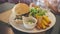 Young hungry Asian female teenager eating her vegan mushroom burger