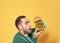 Young hungry man eating huge burger