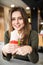 Young hungry woman sitting in a restaurant eating an doner hand hold- hunger, food, meal concept