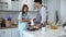 The young husband cooking breakfast in kitchen