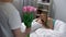 Young husband giving tulips for sleepy wife in morning, flowers delivery