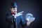 Young illusionist is predicting future and fortune telling from magical ball