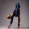 Young and incredibly beautiful ballerina in blue outfit is posing and dancing in studio. art.