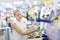 Young independent woman buying tools for house decoration in paint supplies shop.