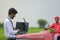 Young indian bank officer using laptop at agriculture field