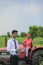 Young indian bank officer using laptop at agriculture field