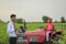 Young indian bank officer using laptop at agriculture field