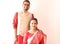 A young indian bengali assamese married couple dressed in red and white ethnic indian dress and smiling