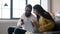 Young Indian Couple Listening Music And Singing At Home