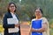 Young Indian entrepreneur woman and her old retired mother standing with a laptop and file in their hand`s in a park in Delhi.