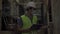 Young Indian factory warehouse worker wearing a protective face mask and safety helmet while working in logistic