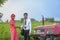 Young indian farmer and bank officer with new tractor at agriculture field