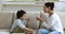 Young Indian female speech therapist work with little preschooler boy