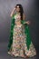 Young Indian female wearing ethnic green floral summer dress with jewelry and makeup