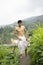 Young Indian fit boy, walking on a pathway beside crops in the field. An Indian priest walking while wearing white dhoti. Indian