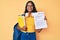 Young indian girl wearing backpack showing a passed exam smiling with a happy and cool smile on face