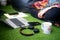 Young indian girl woman sitting cross legged with hands crossed watching content on laptop with headphones and mobile