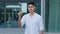 Young indian guy wearing white shirt hiring manager consultant or company employee shows gesture pointing finger at