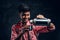 Young Indian hiker pours his own tea from a thermos.